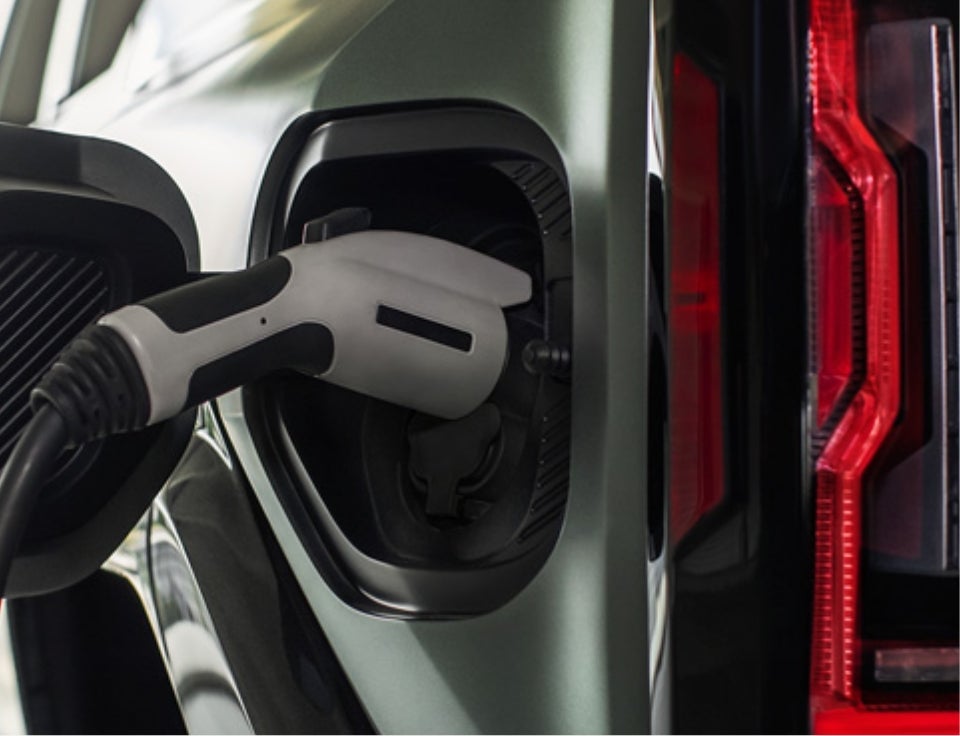 Close up of charging port with charger plugged in on a GMC Hummer EV SUV - Dublin GMC in DUBLIN GA
