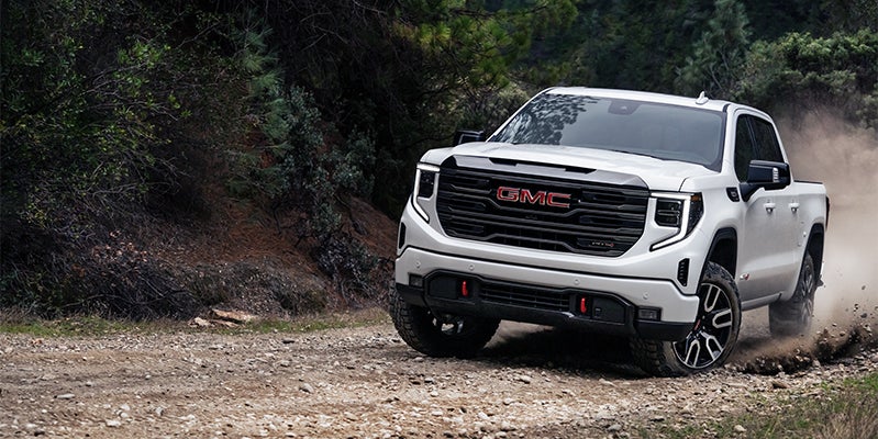 white gmc sierra running offroading