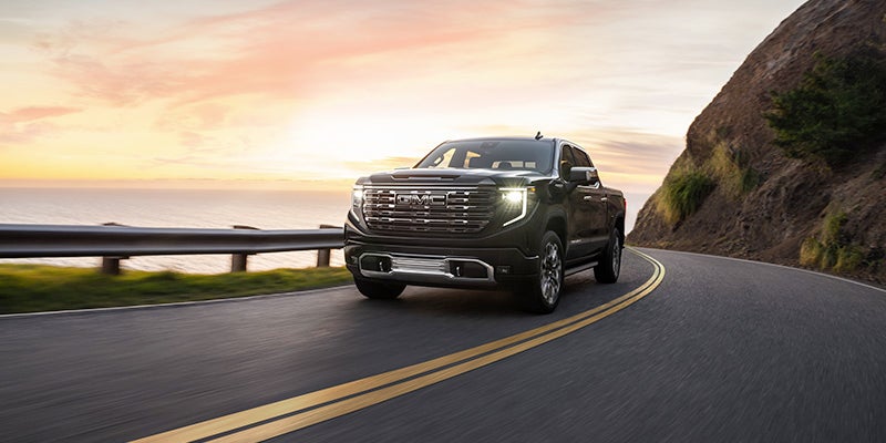 gray gmc sierra 1500 running on road