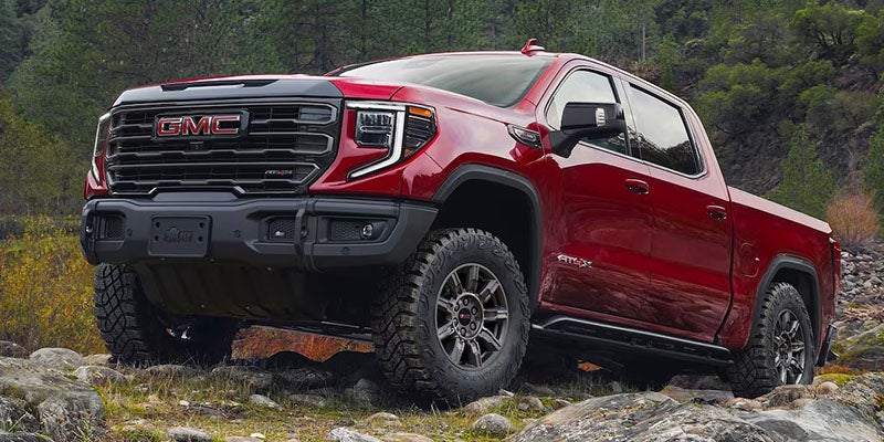 red GMC sierra running offroading