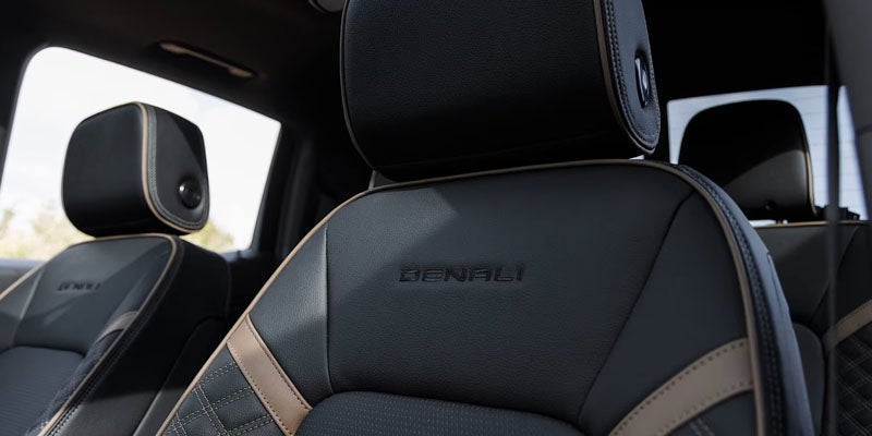 Premium leather front seat inside the 2026 GMC Canyon with Denali branding