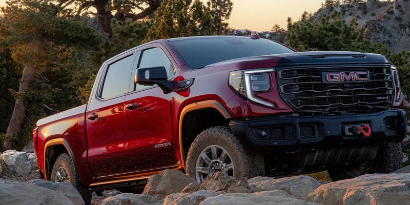 2026 GMC Sierra 1500 driving off-road showcasing powerful performance and capability