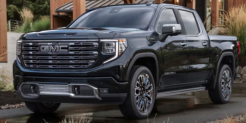 2026 GMC Sierra 1500 displayed outside a modern home highlighting its professional-grade styling and capability